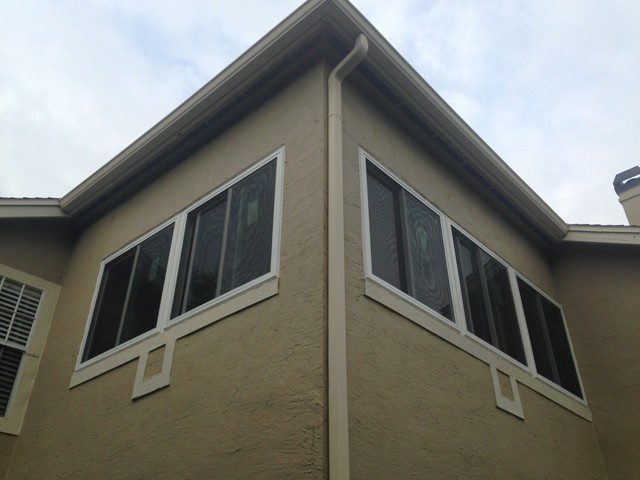 A corner of a building with windows and a sky background