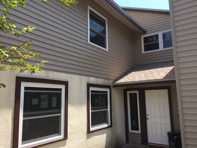 A house with two windows and a door.